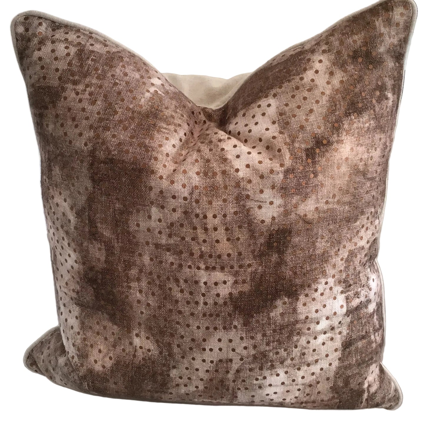A square-shaped pillow with a mauve color and a geometric pattern, consisting of dots and dashes, placed on a white surface.